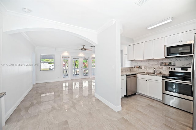 kitchen featuring white cabinets, stainless steel appliances, ceiling fan, and sink