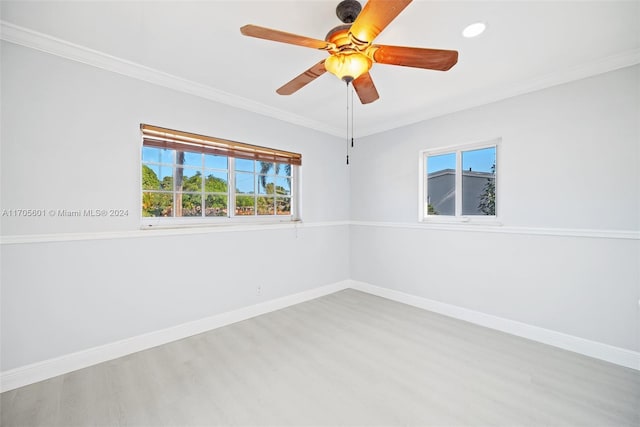 unfurnished room with ceiling fan, crown molding, and light wood-type flooring