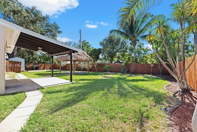 view of yard with a gazebo, ceiling fan, and a patio area