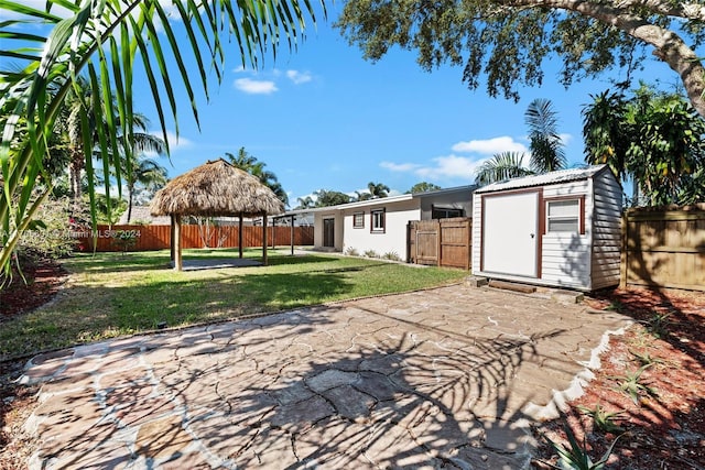 view of yard featuring a gazebo and a storage unit