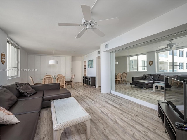 living room with ceiling fan and light hardwood / wood-style floors