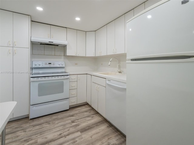 kitchen with sink, white cabinetry, light wood-type flooring, white appliances, and decorative backsplash