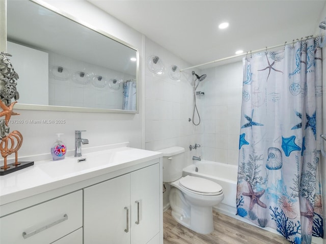 full bathroom with vanity, hardwood / wood-style flooring, toilet, and shower / bath combo with shower curtain