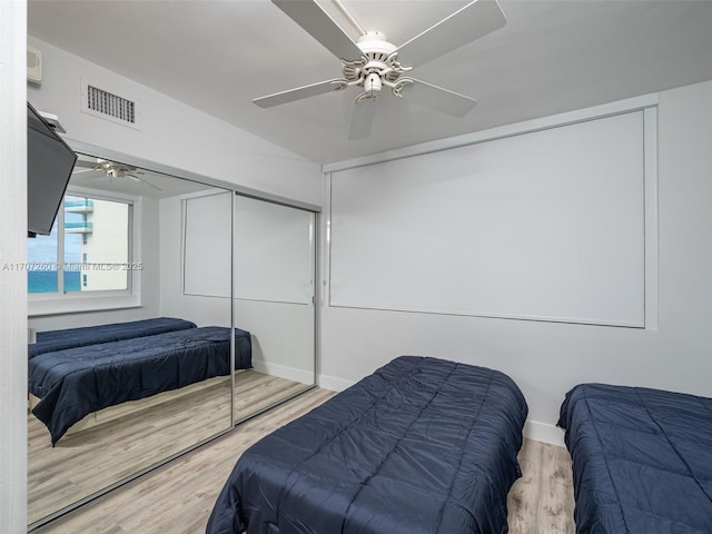 bedroom with ceiling fan, a closet, and light wood-type flooring