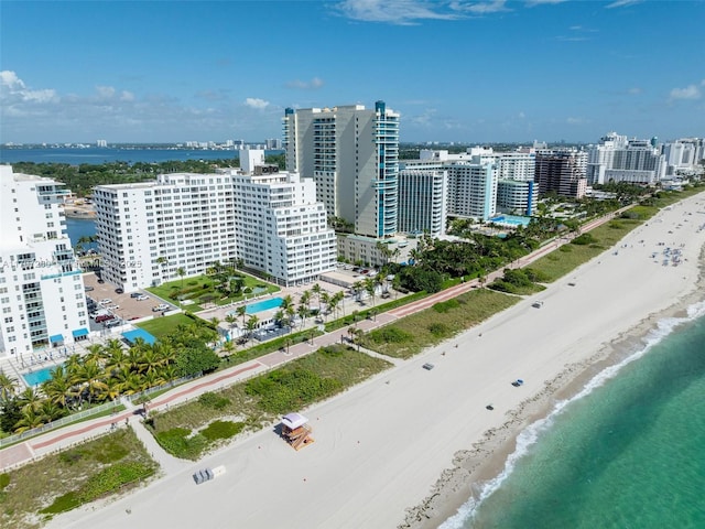 bird's eye view featuring a view of the beach and a water view