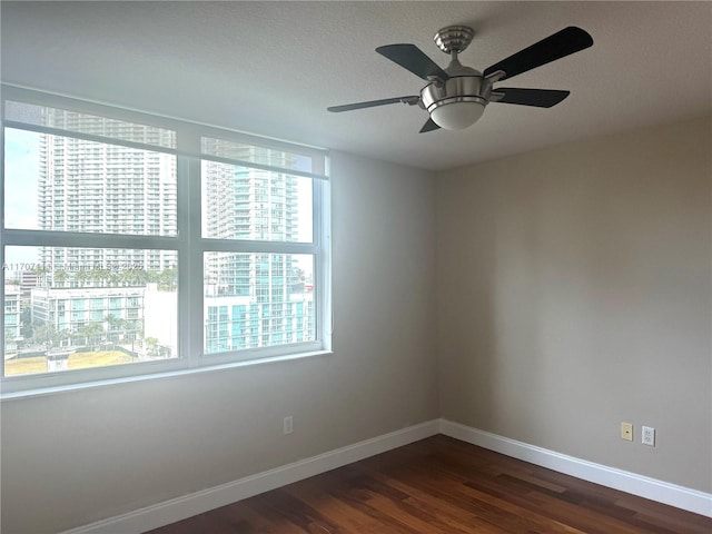 unfurnished room featuring ceiling fan and dark hardwood / wood-style floors