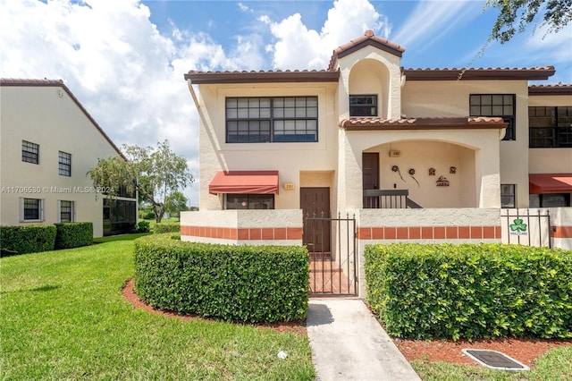 mediterranean / spanish home with a front yard