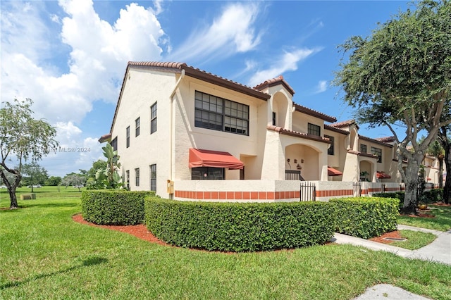 mediterranean / spanish-style home with a front lawn