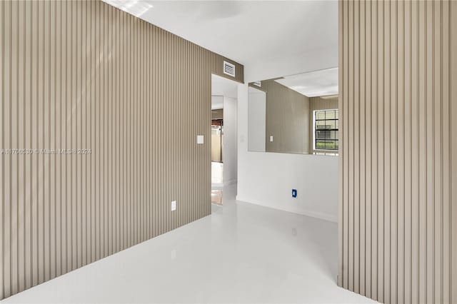 tiled empty room with a textured ceiling