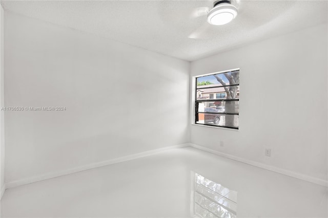 unfurnished room with a textured ceiling