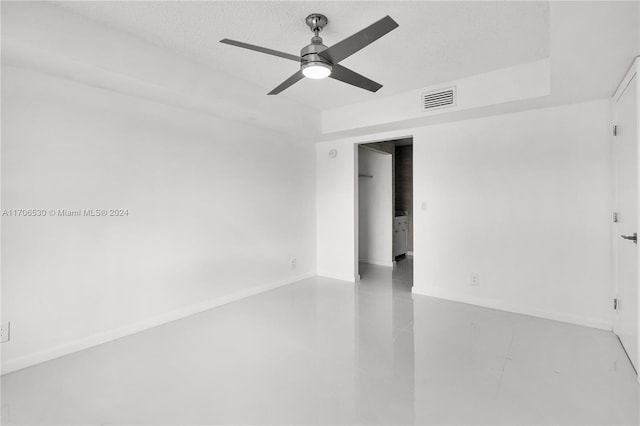 unfurnished room featuring a textured ceiling, ceiling fan, and concrete floors