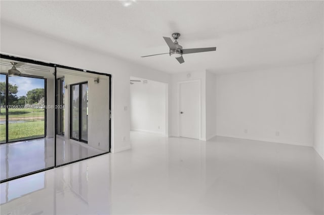 spare room with ceiling fan and a textured ceiling