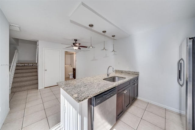 kitchen with sink, hanging light fixtures, kitchen peninsula, and appliances with stainless steel finishes