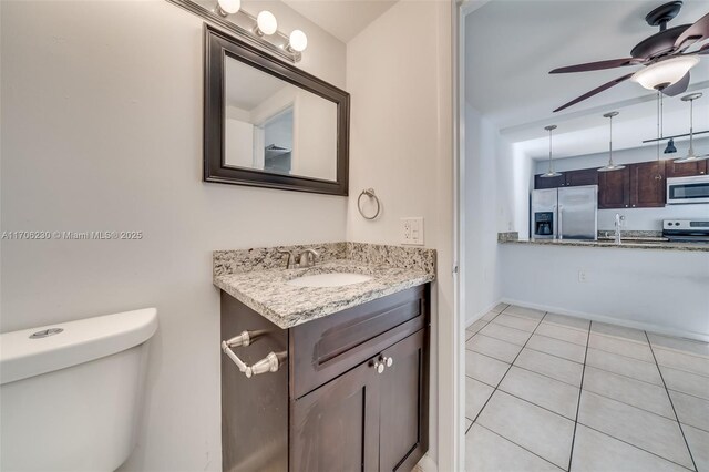 interior space featuring built in shelves, ceiling fan, and light tile patterned flooring