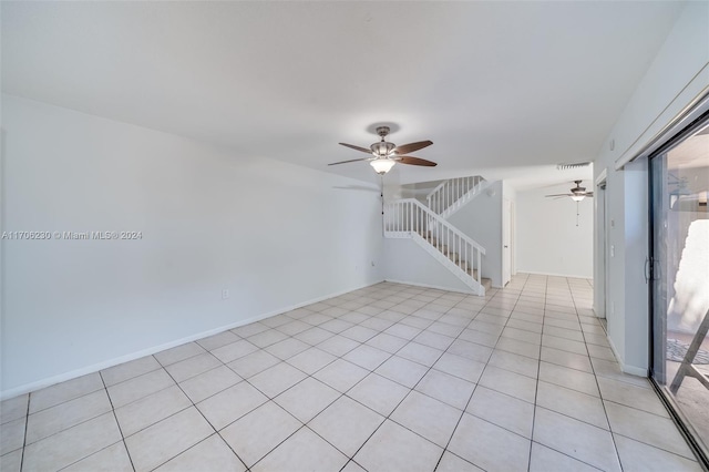 spare room with ceiling fan and light tile patterned floors