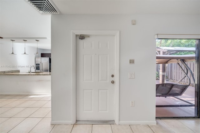 tiled foyer featuring sink