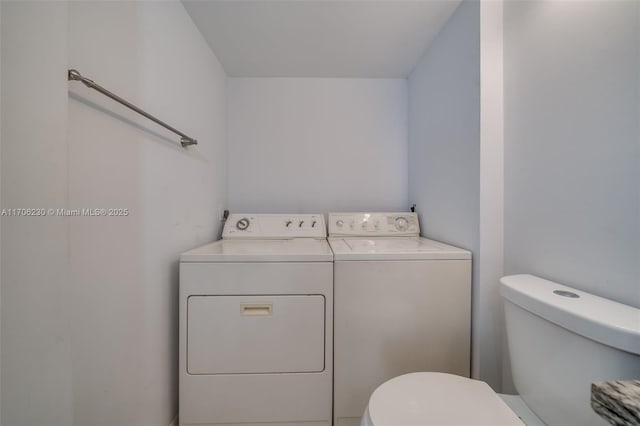 clothes washing area featuring separate washer and dryer