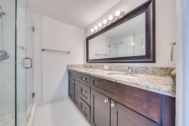 bathroom featuring tile patterned floors, vanity, and an enclosed shower