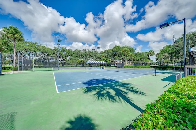 view of tennis court featuring basketball hoop