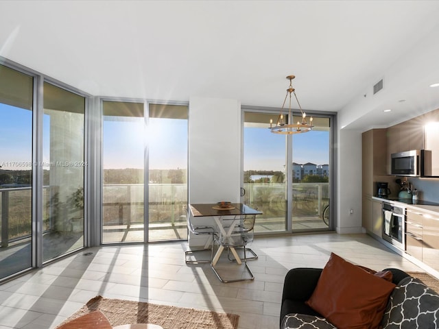 interior space with floor to ceiling windows, plenty of natural light, and a chandelier