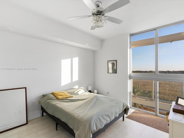 bedroom with access to outside and ceiling fan