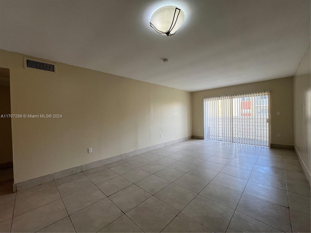 unfurnished room with light tile patterned floors