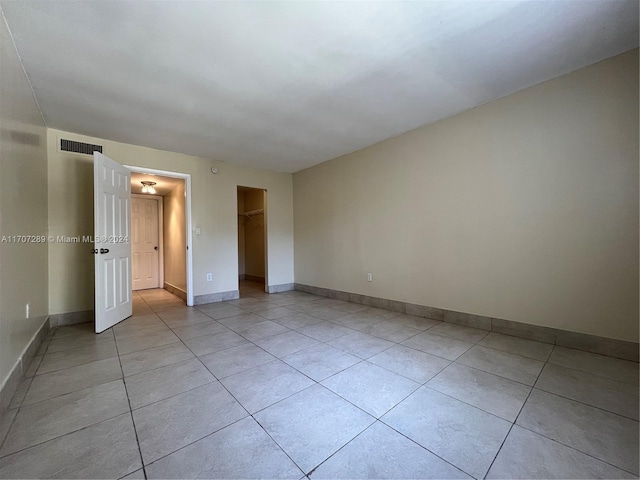 3700 NW 21st St Unit 304, Lauderdale Lakes, FL 33311 - unfurnished bedroom featuring light tile patterned floors, a closet, and a walk in closet