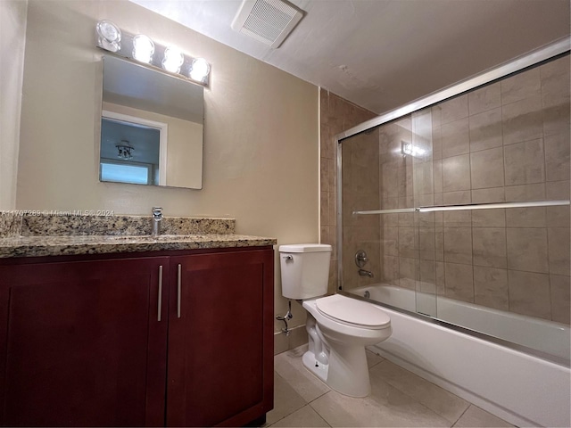 full bathroom with tile patterned floors, vanity, toilet, and shower / bath combination with glass door