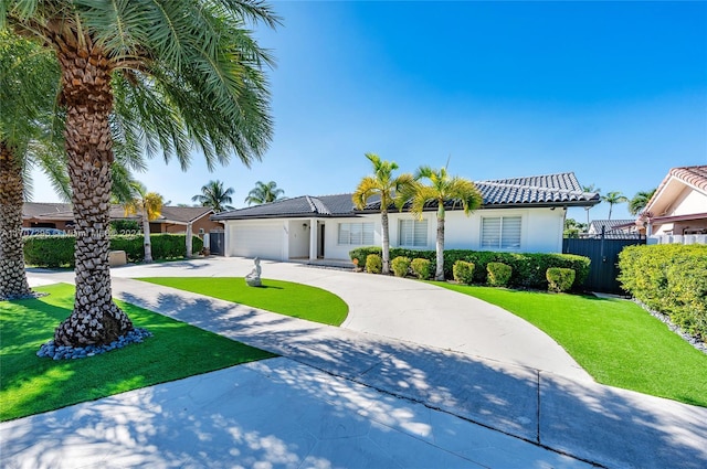 view of front facade featuring a front yard and a garage