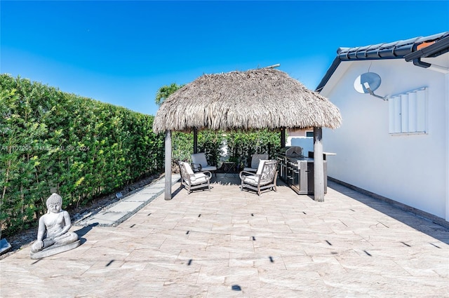 view of patio / terrace featuring a gazebo, a grill, and an outdoor hangout area