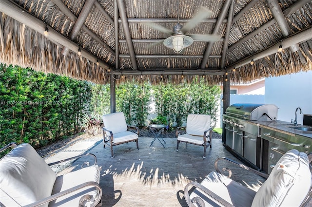 view of patio with a gazebo, area for grilling, ceiling fan, and a grill