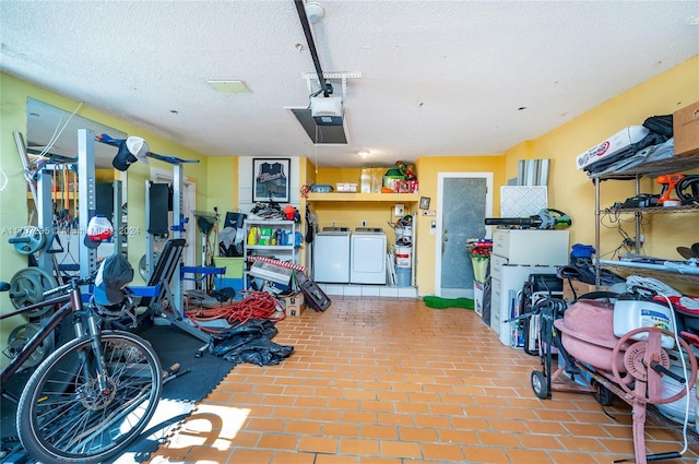 garage featuring independent washer and dryer and a garage door opener