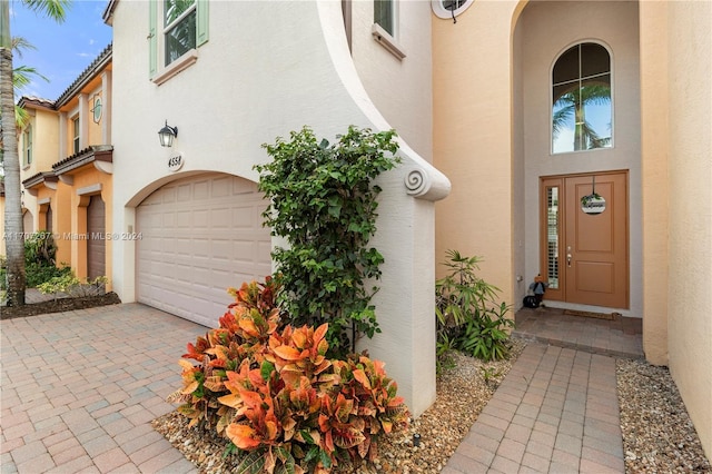 doorway to property with a garage