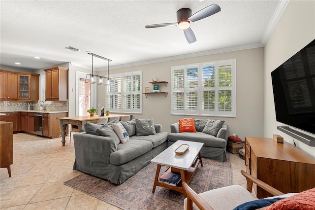 tiled living room featuring a wealth of natural light, ceiling fan, a textured ceiling, and ornamental molding