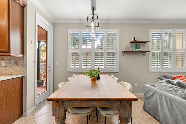 dining space with crown molding, light tile patterned flooring, and a healthy amount of sunlight