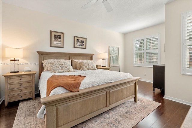 bedroom with ceiling fan and dark wood-type flooring