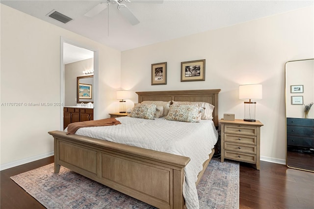 bedroom with ensuite bath, ceiling fan, and dark wood-type flooring