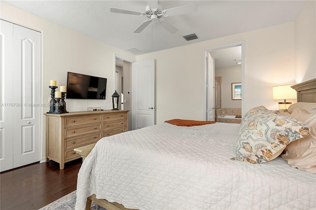 bedroom with a closet, ensuite bath, ceiling fan, and dark wood-type flooring