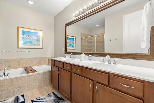 bathroom featuring shower with separate bathtub, vanity, and tile patterned floors