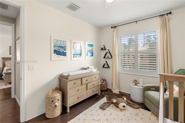 bedroom with dark hardwood / wood-style floors