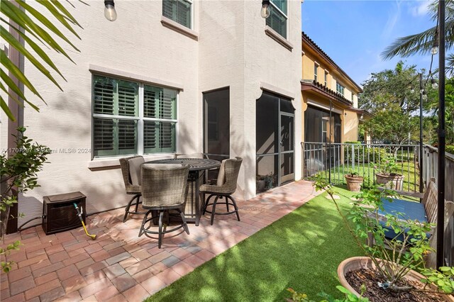 view of patio with a sunroom