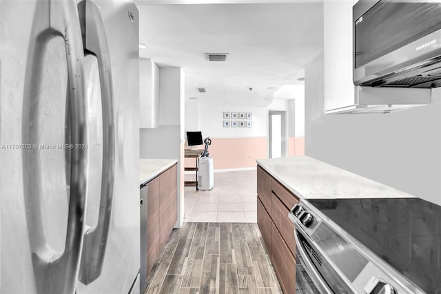 kitchen with light wood-type flooring and stainless steel appliances