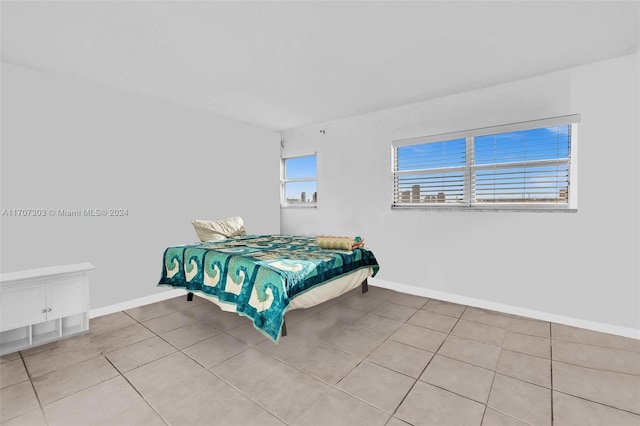 bedroom with light tile patterned floors