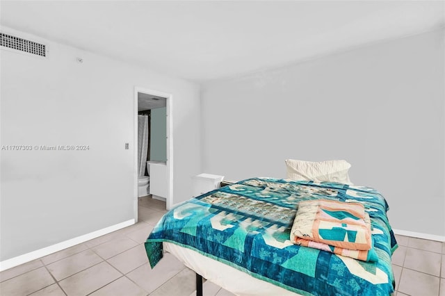 tiled bedroom with connected bathroom