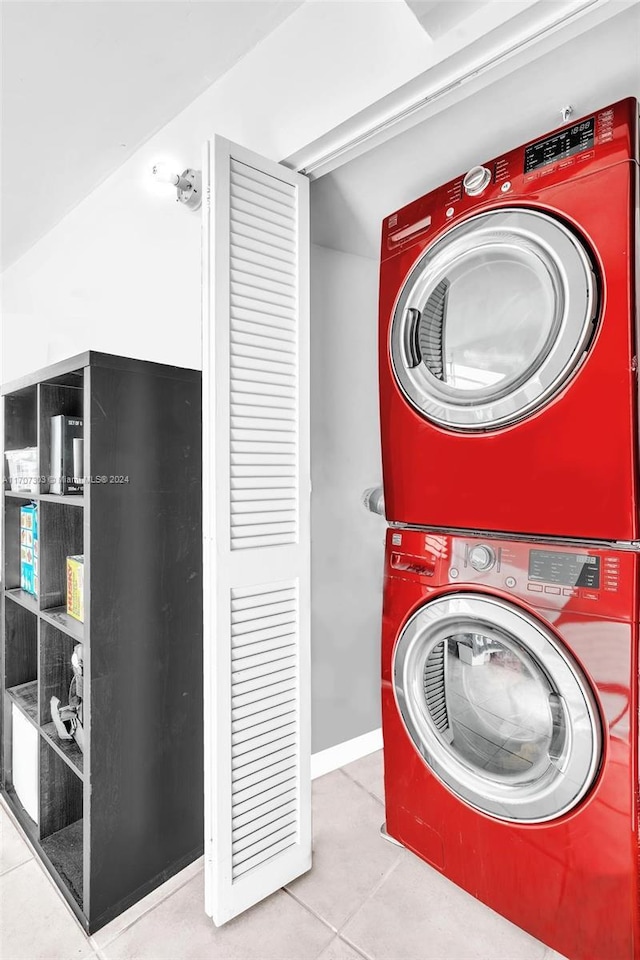 laundry room with light tile patterned floors and stacked washer and dryer