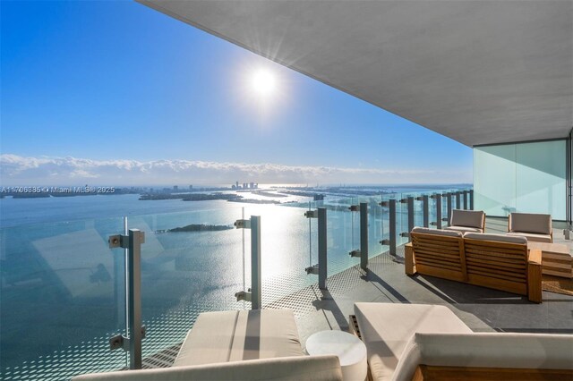 balcony with outdoor lounge area and a water view