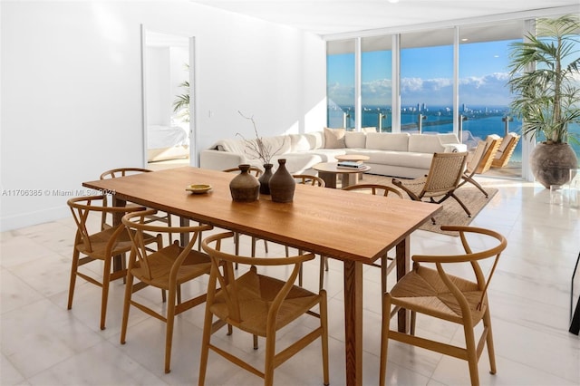 dining room with a water view and floor to ceiling windows