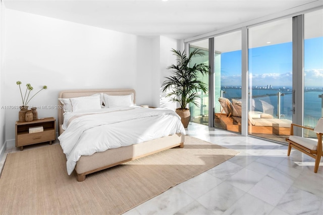 bedroom with access to outside, a water view, and floor to ceiling windows