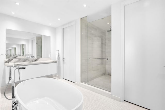 bathroom with tile patterned floors, vanity, and independent shower and bath