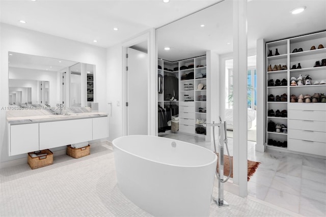 bathroom with vanity and a tub